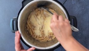 stirring grated parmesan cheese into pasta in instant pot