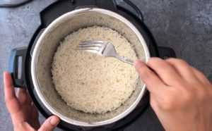 Fluffing cooked rice with a fork