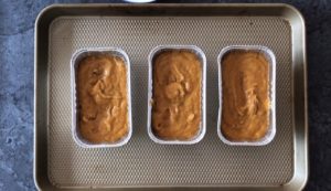 pumpkin bread batter in three mini loaf pans