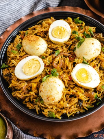 Spiced rice topped with boiled egg halves and cilantro