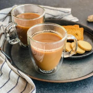 Two cups of Indian tea served with cookies