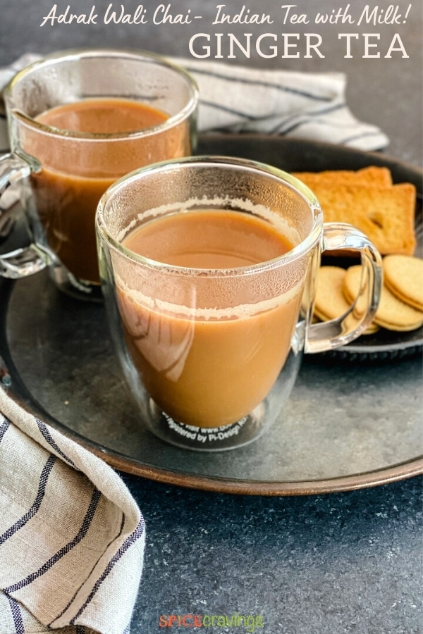 A cup of Indian tea with milk on a grey tray