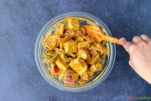 paneer, peppers and onions marinating in glass bowl