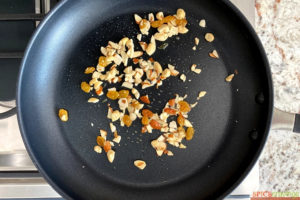 Sauteing nuts and raisins in a skillet