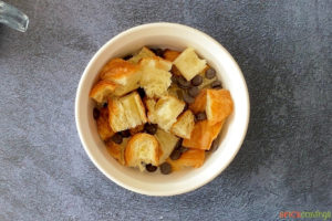 Pieces of croissants and chocolate chips in a bowl
