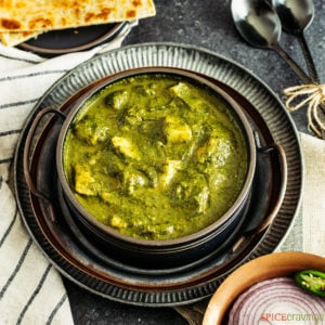 Indian spinach potato curry in a metal plate