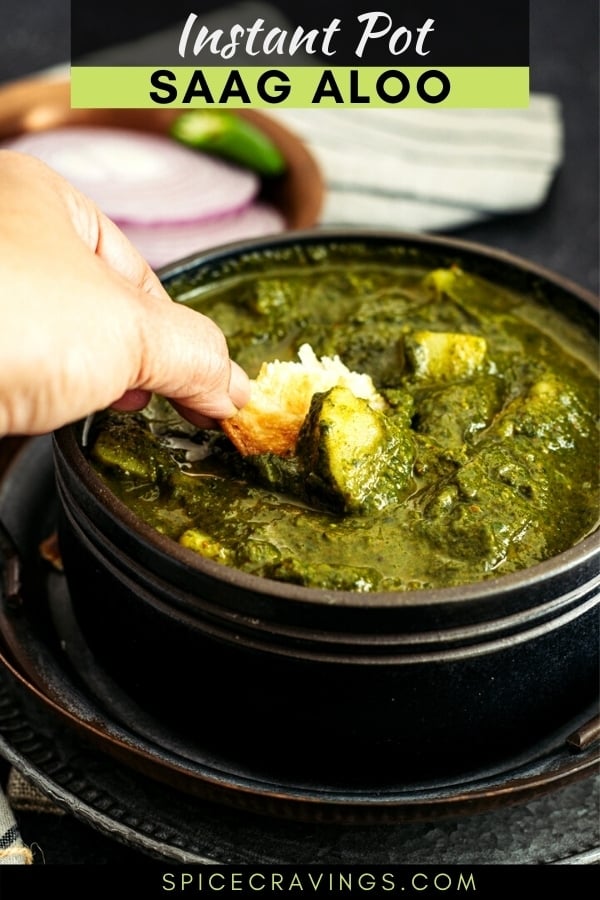 Scooping Saag Aloo with paratha