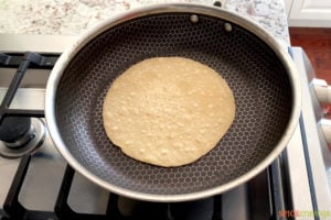 Indian chapati being cooked in a non stick pan