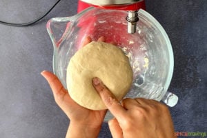 Pressing roti dough with index finger