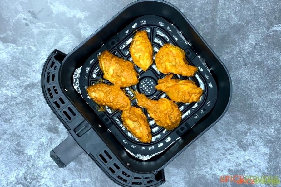Chicken wings inside of an air fryer basket