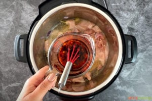 Kung Pao sauce being poured into an Instant Pot