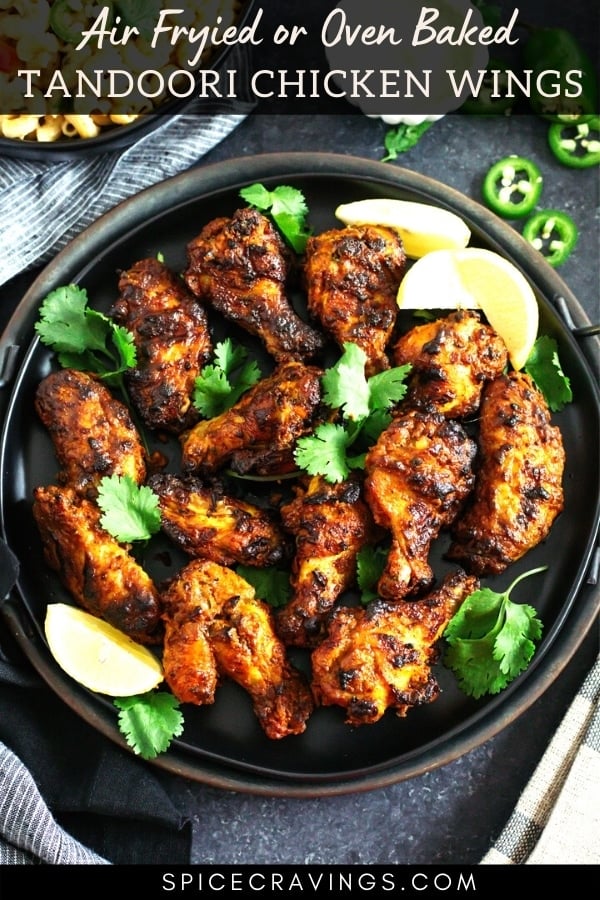 Tandoori chicken wings on a black tray