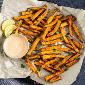 Air fried sweet potato fries on a plate with parchment paper