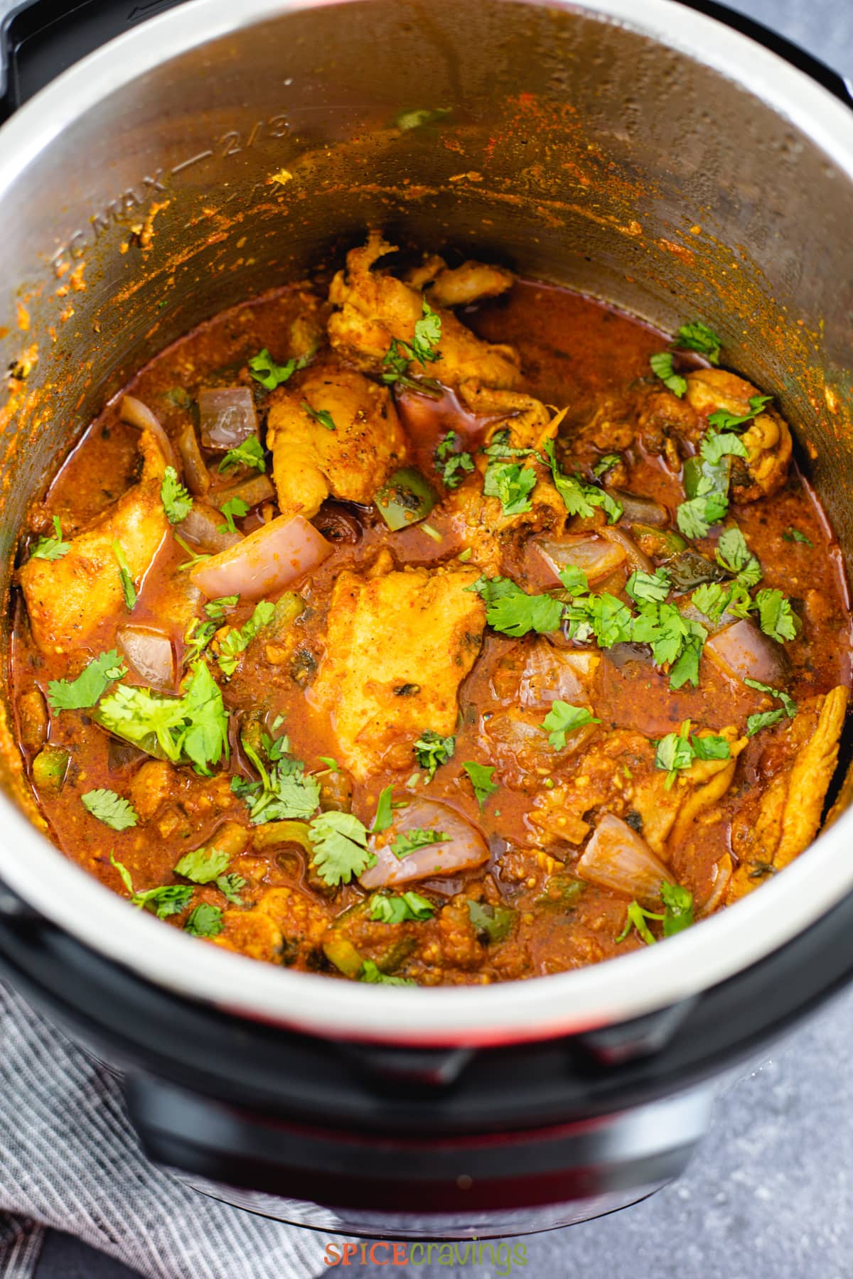Indian chicken curry in instant pot garnished with cilantro