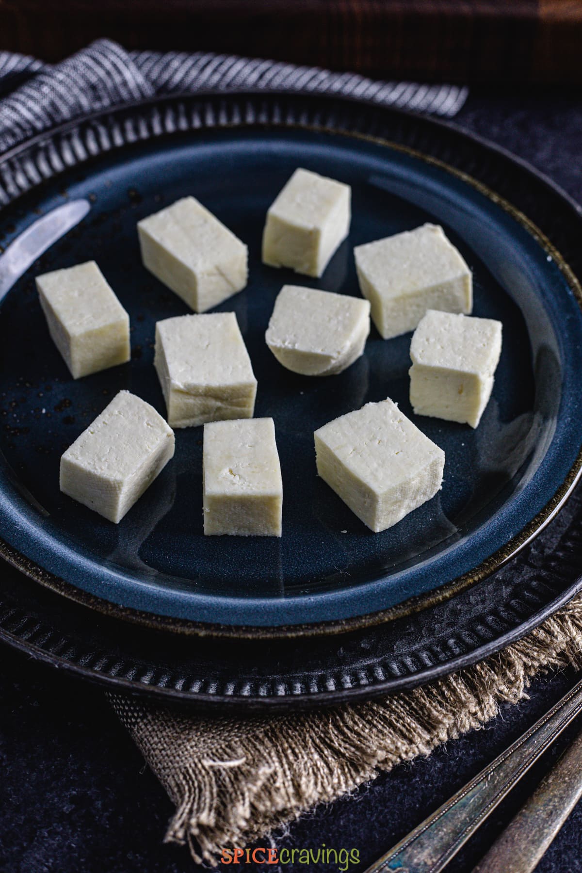 Cubes of homemade paneer on a plate