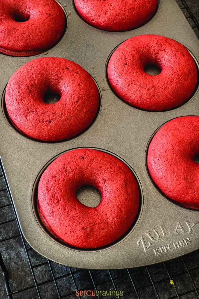 Baked red velvet donuts in a baking tin