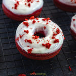 Red Velvet Donuts with cream cheese frosting on a wire rack