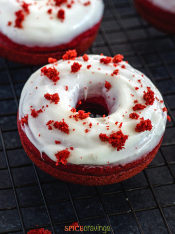 Red Velvet Donuts with cream cheese frosting on a wire rack