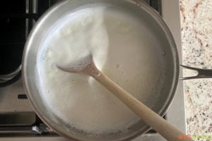 Stirring milk boiling on a stove top