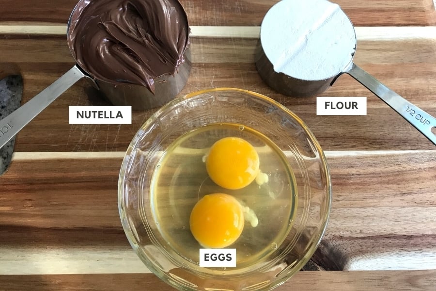 Eggs, Flour and nutella on a cutting board