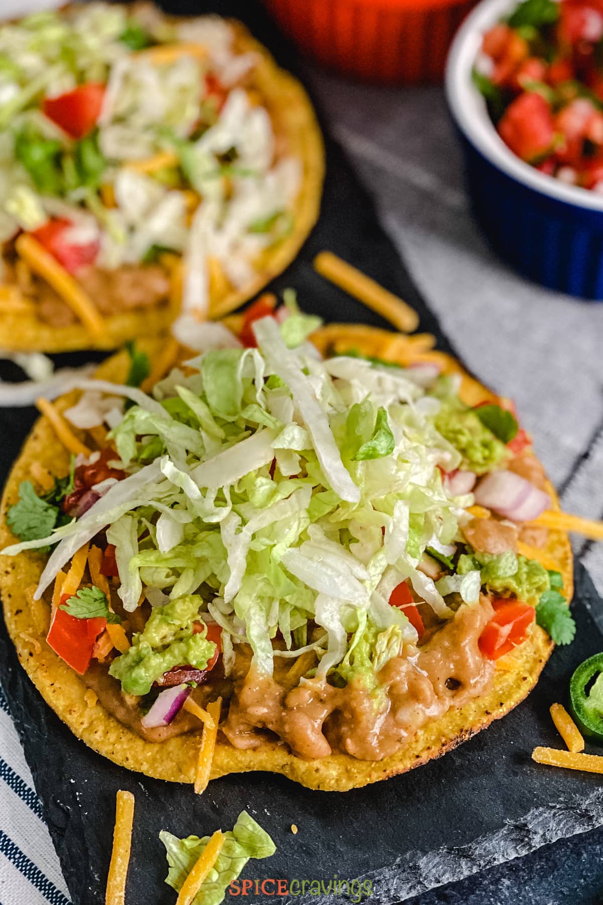 Crisp tortilla topped with lettuce, beans and tomato