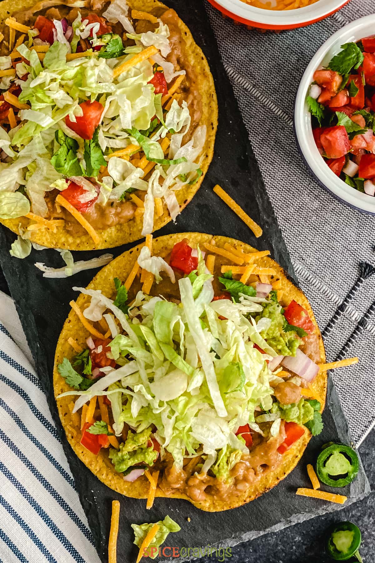 Crispy Tortillas topped with lettuce, beans, tomato and cheese