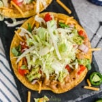 Tostada with lettuce, beans, tomato and cheese