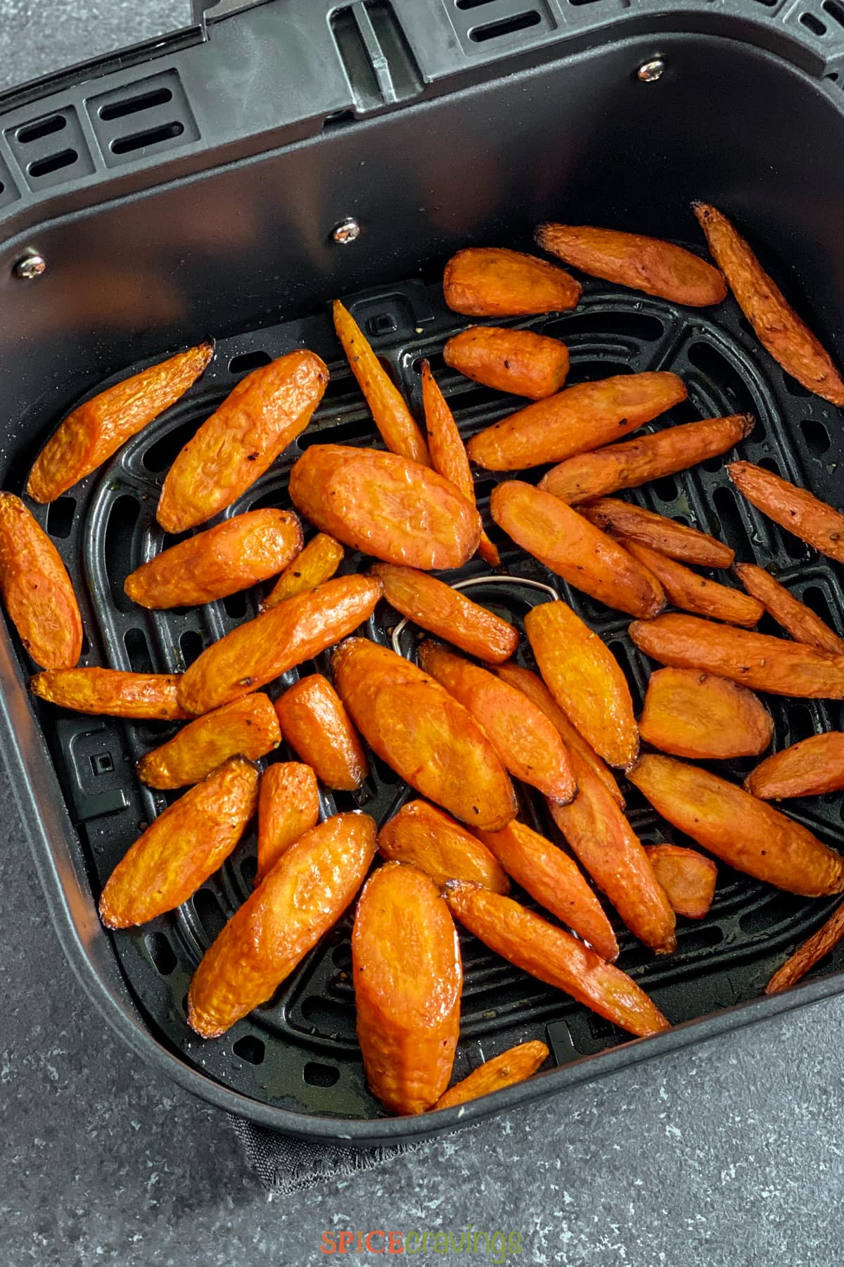Roasted sliced carrots in air fryer basket