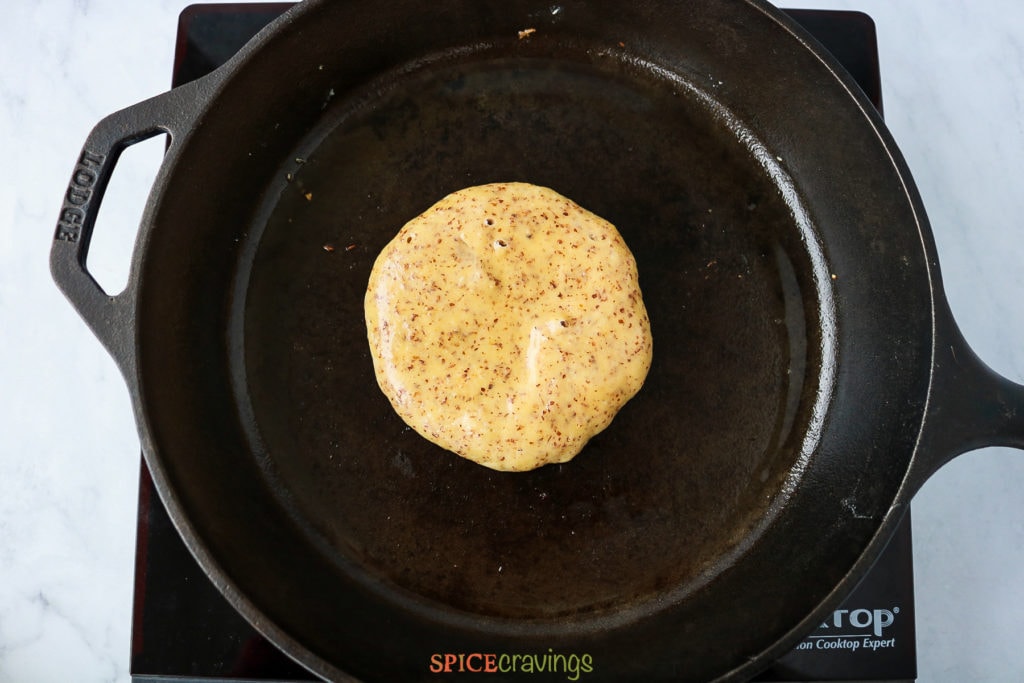 Pancake with air bubbles in a skillet