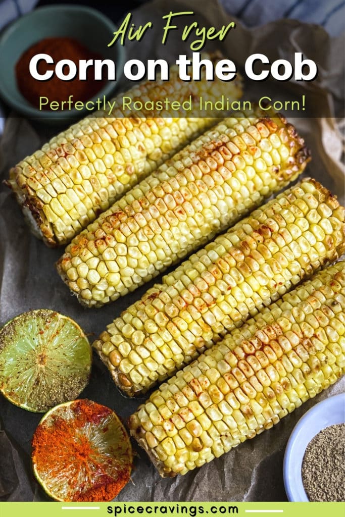 4 ears of roasted corn next to spices and lime halves