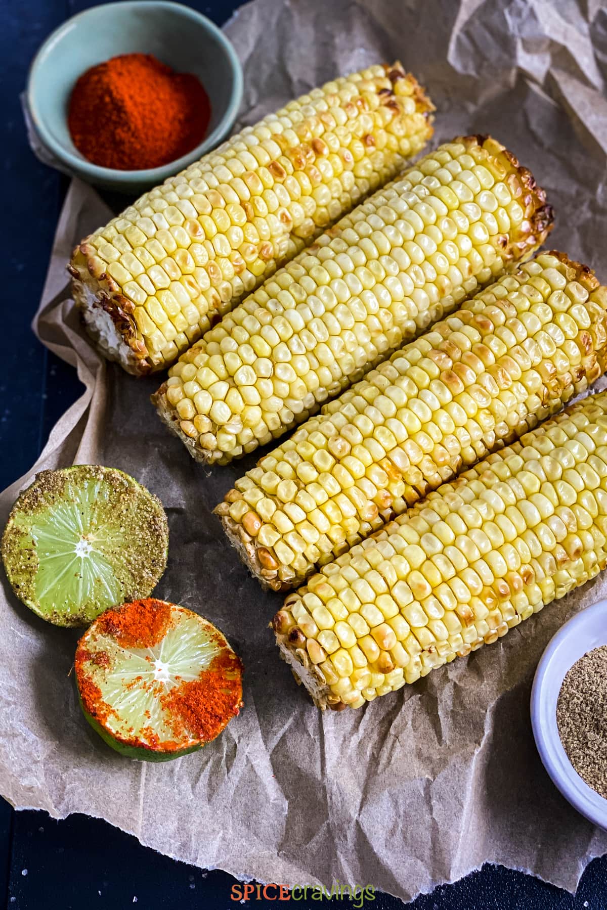 roasted corn on parchment, with spices and lime