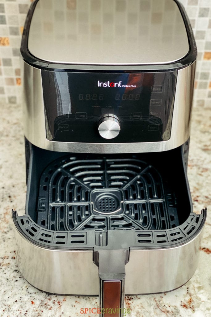Air fryer on counter with open basket