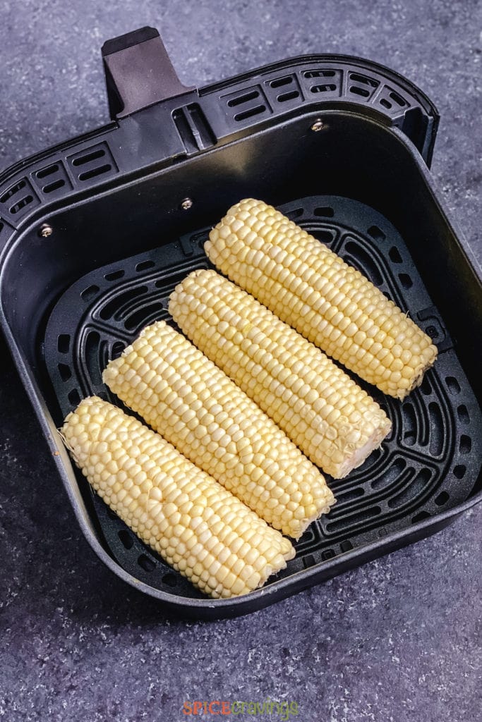 4 ears of corn placed in the air fryer basket