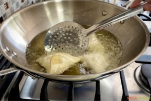 deep frying samosas in hot oil