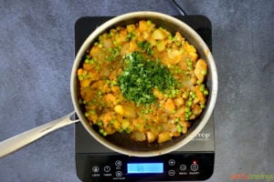 cilantro and vegetable samosa filling in skillet