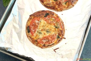 Cooked pizza with tomato and bail