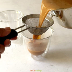 pouring masala chai through strainer