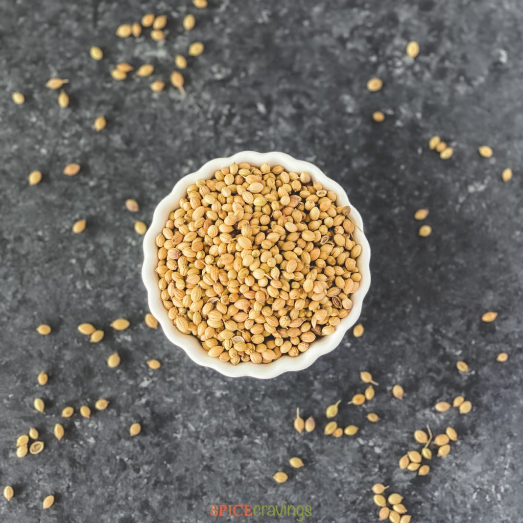 whole corainder seeds in white bowl