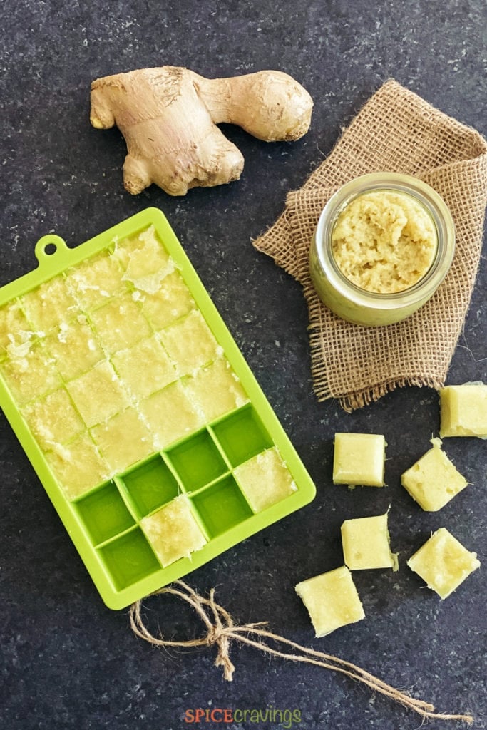 ginger paste cubes in green ice cube tray, fresh ginger root and ginger paste