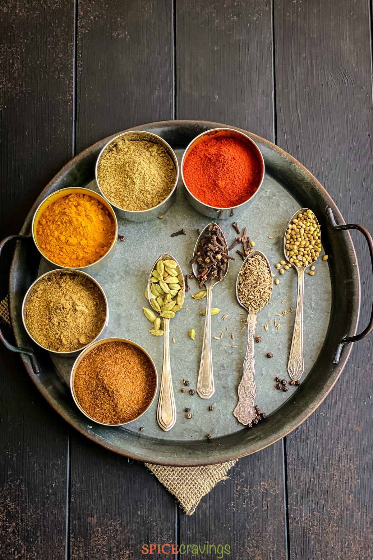 A tray with assorted whole and ground Indian spices