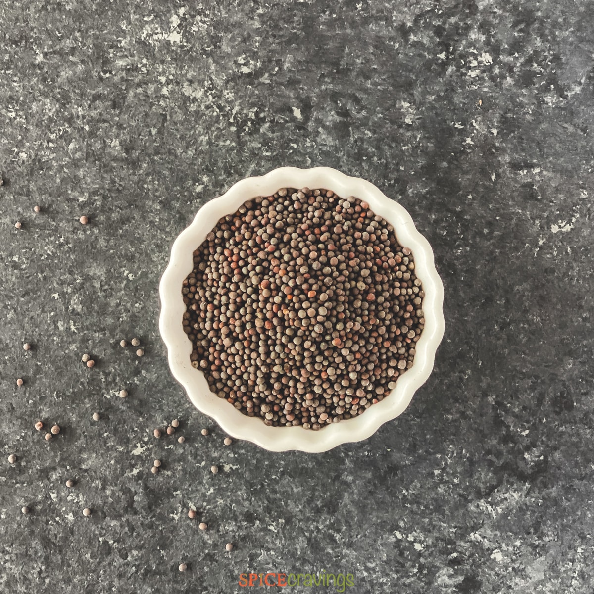 black mustard seeds in white bowl