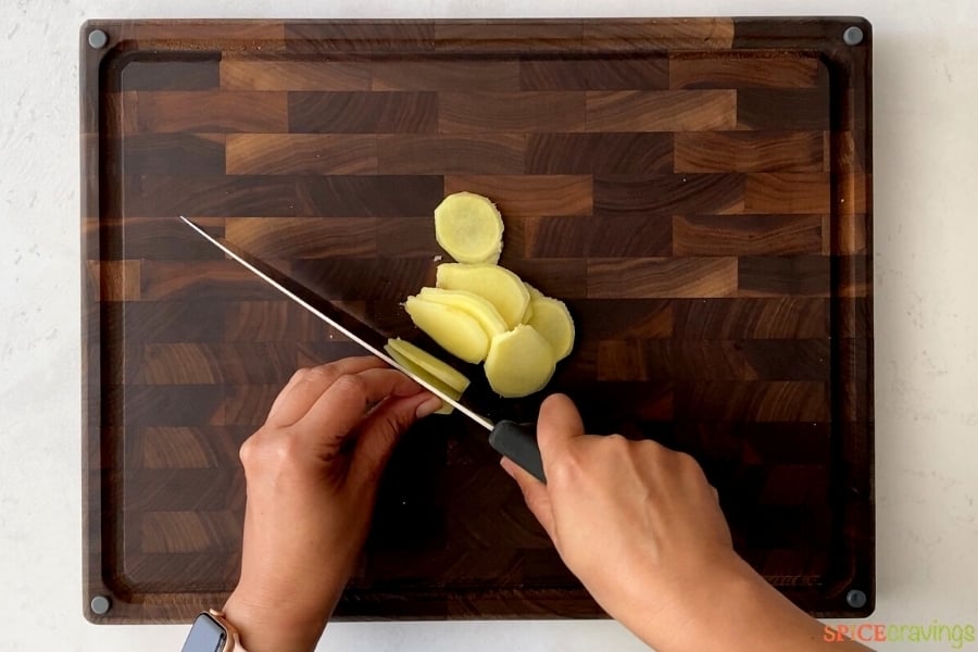 Slicing ginger on a cutting board