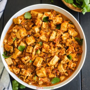 Braised tofu in spicy sauce served in a white bowl
