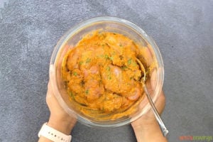 Marinating chicken with Indian spices, yogurt and cilantro