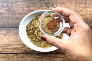 Mixinng ground nutmeg in ground garam masala spice