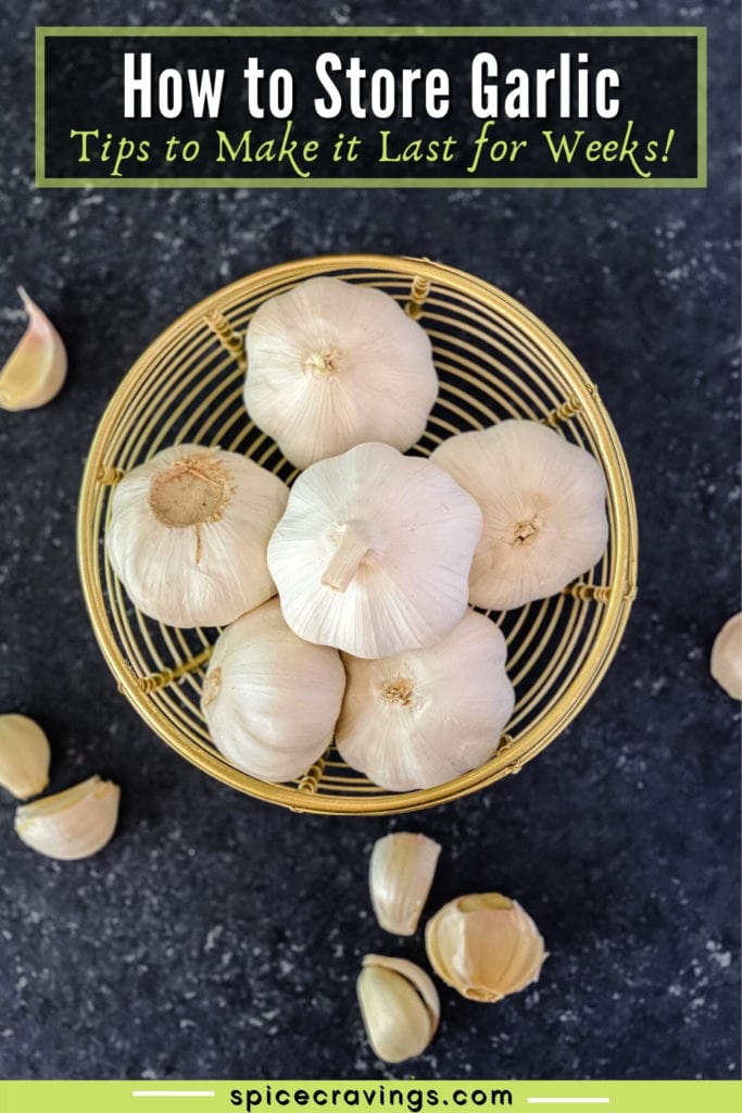 six whole garlic heads in wooden bowl