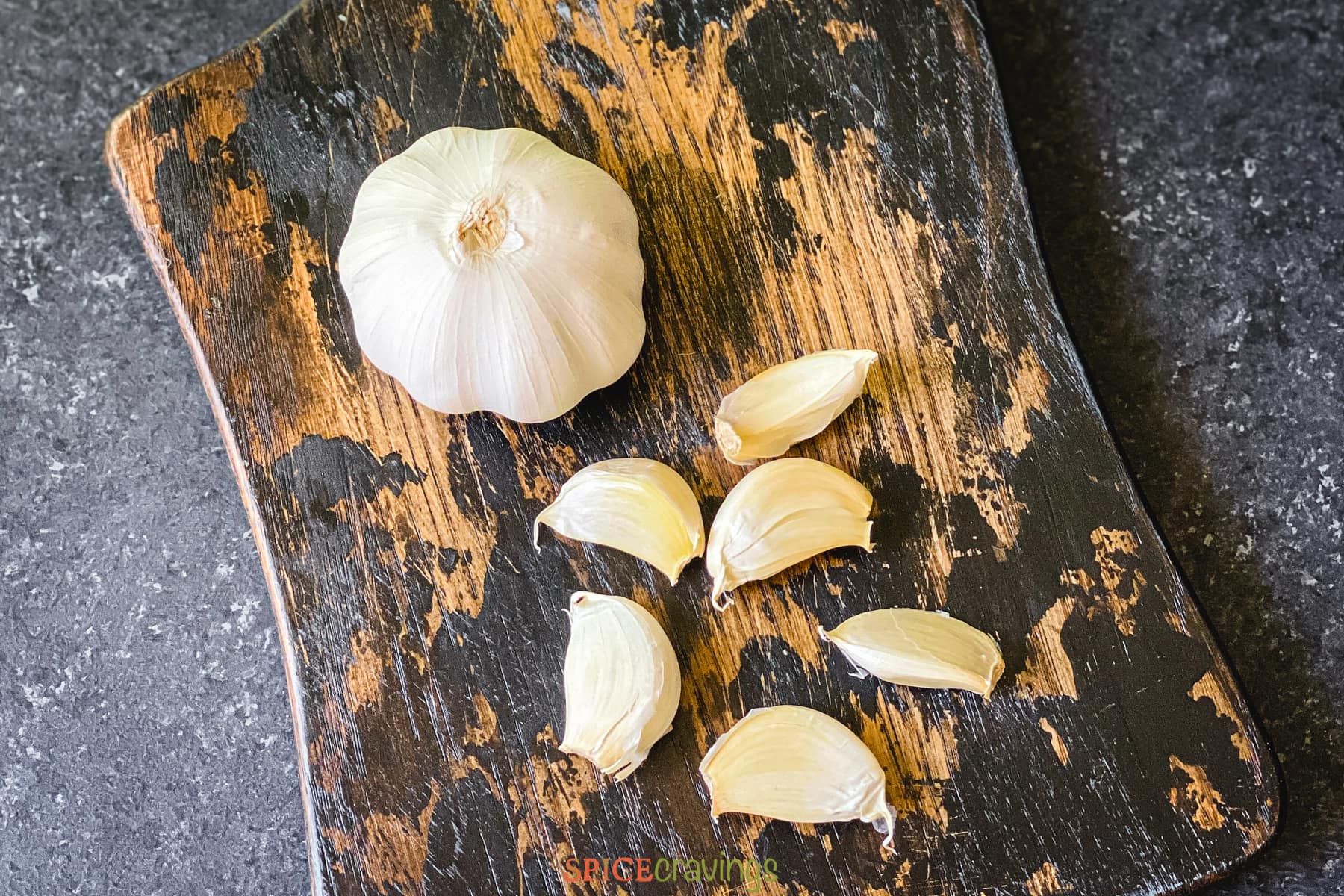 whole garlic head and six unpeeled garlic cloves