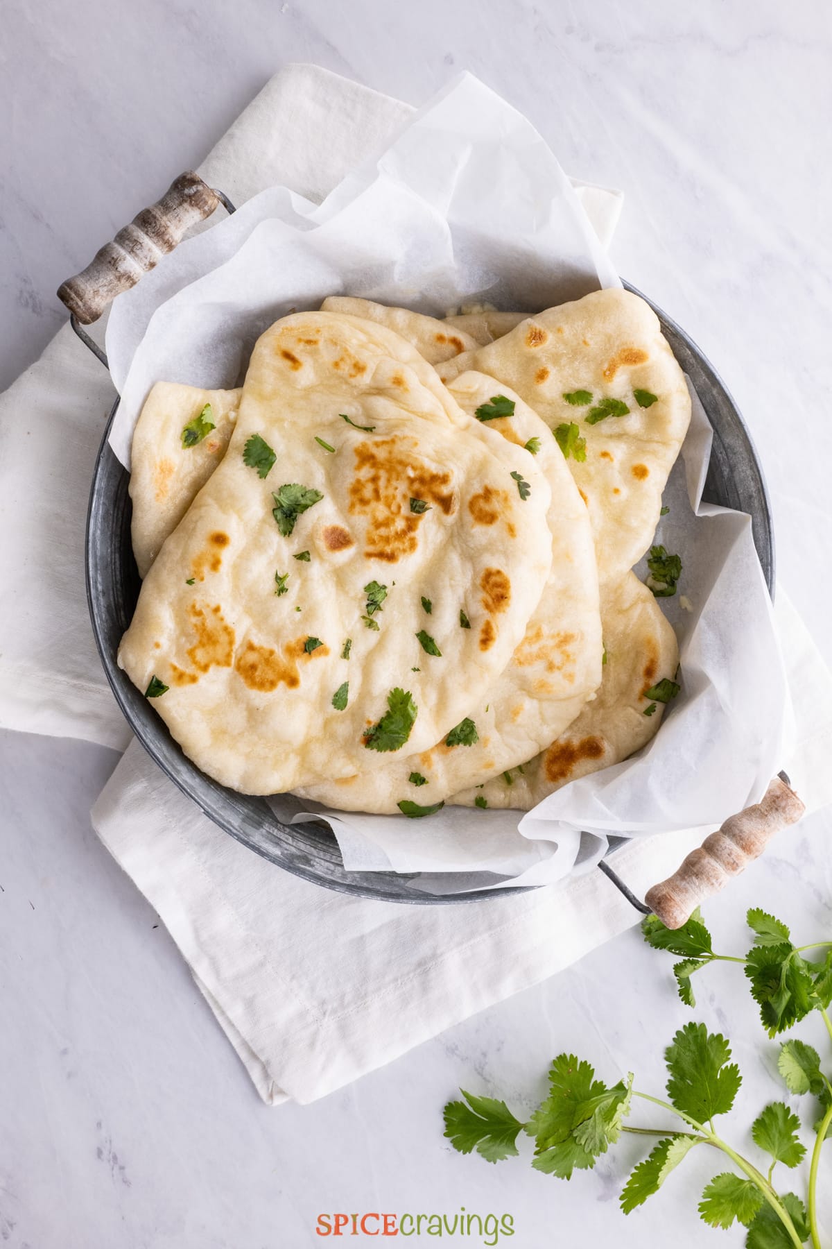 naan bread in bowl with kitchen towel