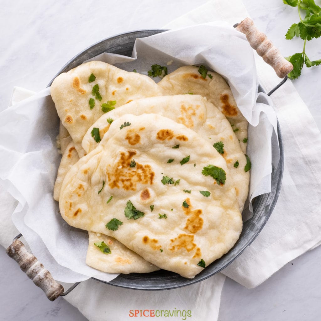 instant naan bread in bowl with kitchen towel