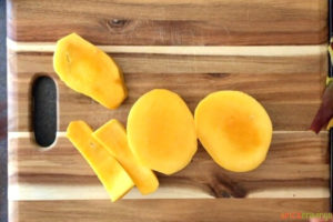 Mango slices on wooden board